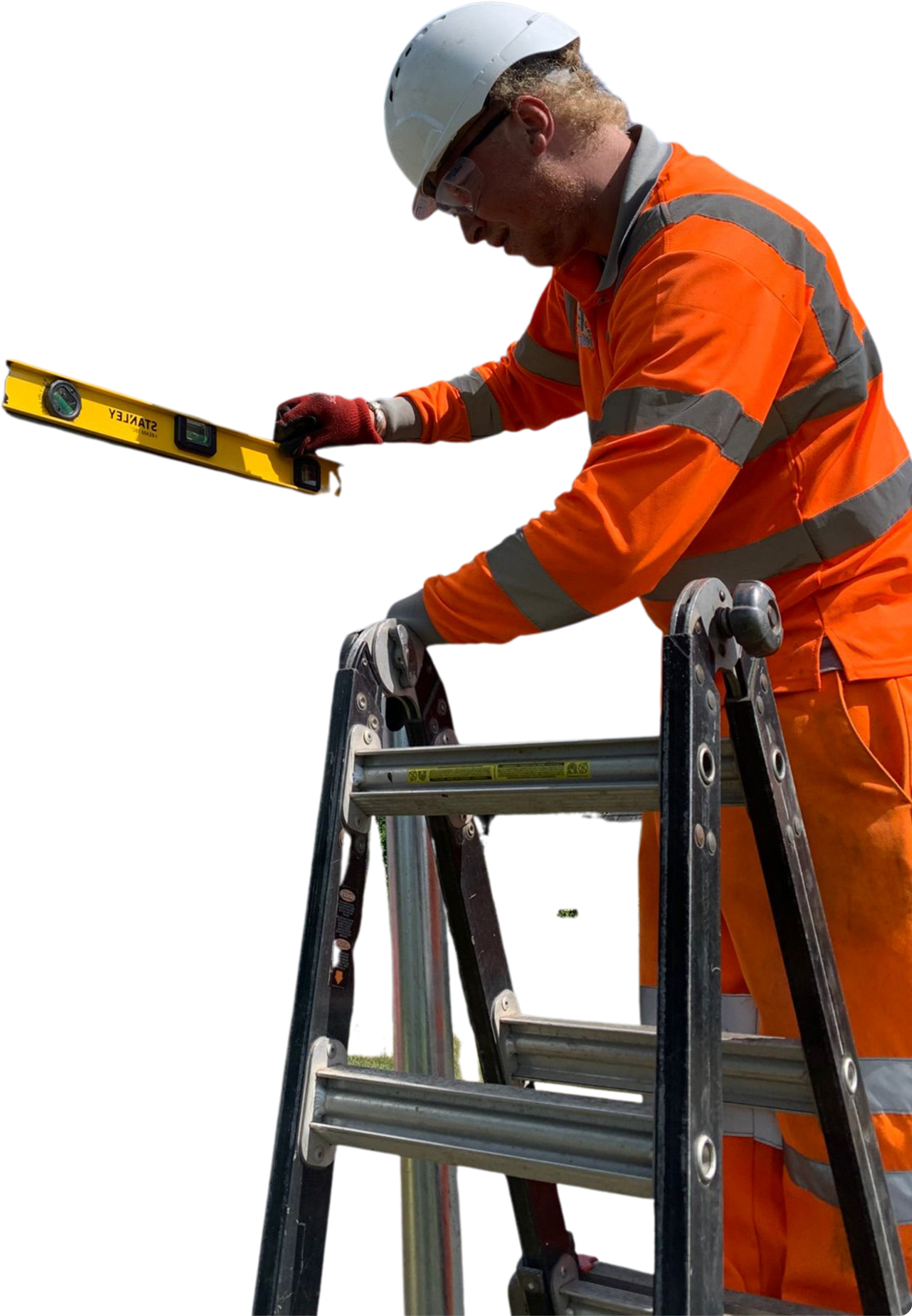 A white male in orange high vis outfit and yellow hard hat up a pair of ladders using a spirit level.