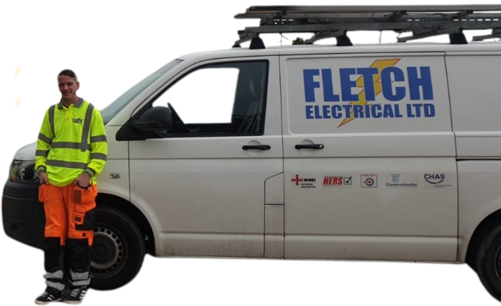 Adrian, a white man in high vis clothing is stood next to his white panel van that has the Fletch Electrical logo on it